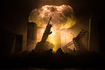 Nuclear war concept. Explosion of nuclear bomb. Apocalyptic view of city downtown after bombing. Night scene. City destroyed by war.